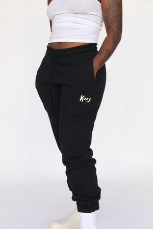 Kozy sweatpants in black. Model is 5'7" and wearing a size small.